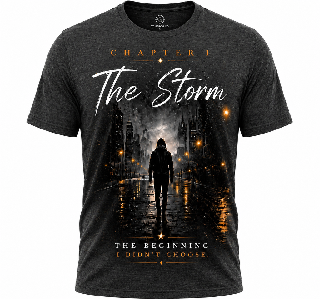 A dark heather gray graphic t-shirt featuring a cinematic print of a lone figure walking down a wet city street at night, with glowing streetlights and the text 'CHAPTER 1 The Storm' and 'THE BEGINNING I DIDN'T CHOOSE.'.