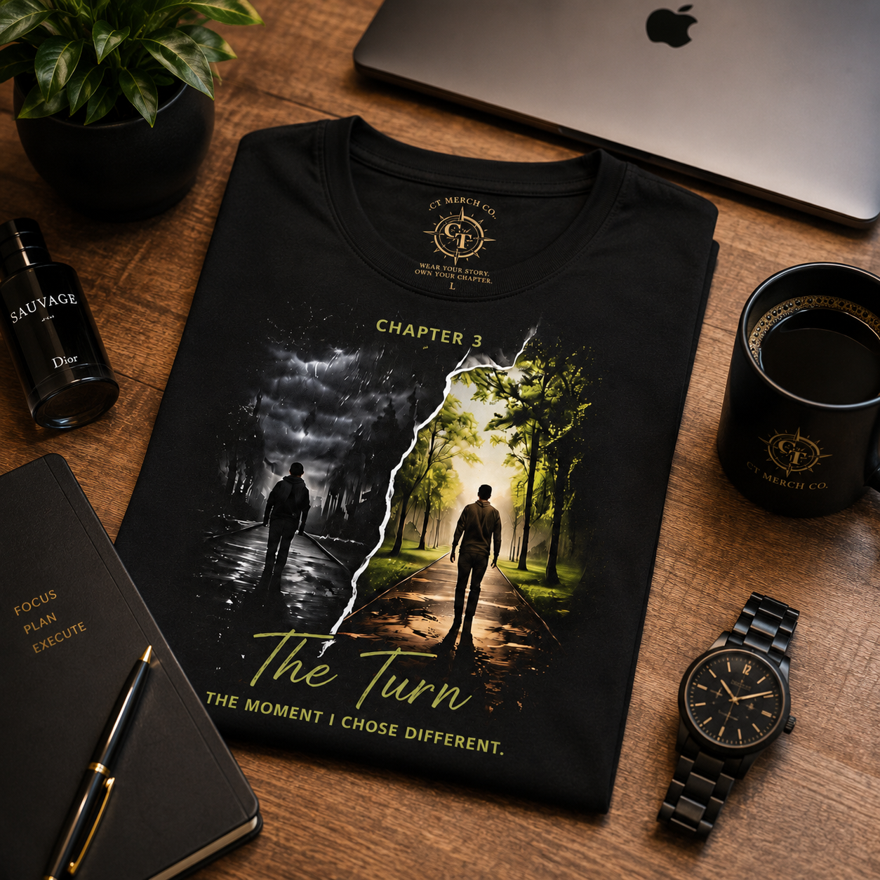 Flat lay of the CT Merch Co Chapter 3 "The Turn" black graphic T-shirt displayed with premium lifestyle accessories including a coffee mug, notebook, pen, watch, fragrance, and laptop, showcasing a luxury everyday lifestyle centered on growth, transformation, and purposeful living.