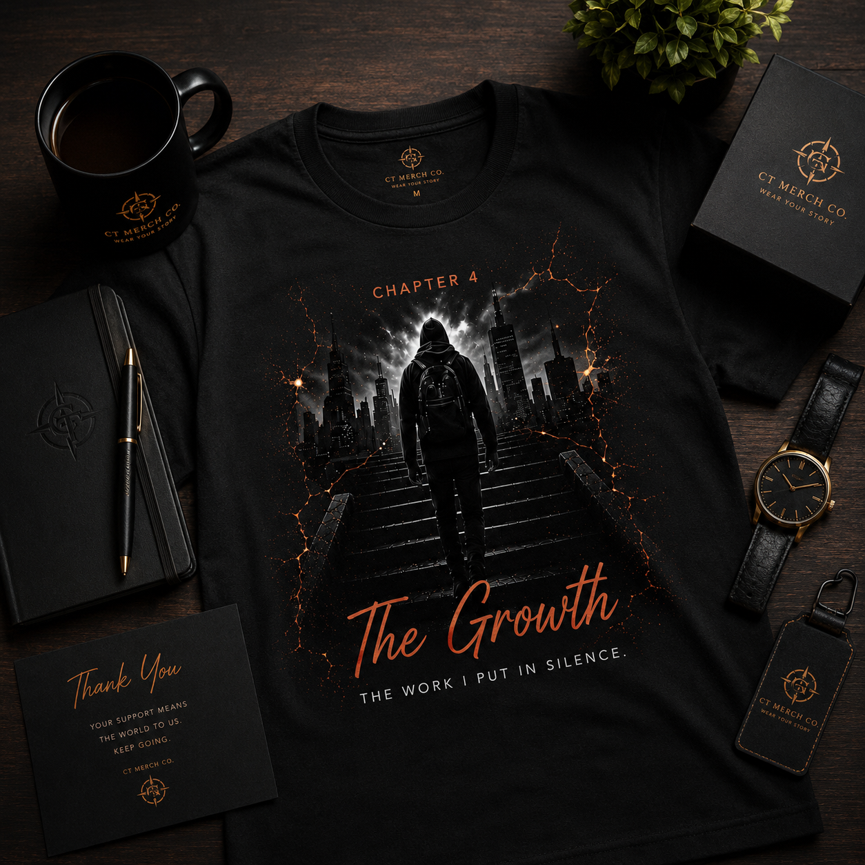 Flat lay of the CT Merch Co Chapter 4 "The Growth" black graphic T-shirt with premium accessories including a coffee mug, notebook, watch, pen, plant, and CT Merch Co branding, showcasing a luxury lifestyle presentation.